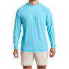 Close-up of a man wearing the Marsh Hoodie in sea island blue color with cream white color pants, cropped from chin to knees, against a solid white background.