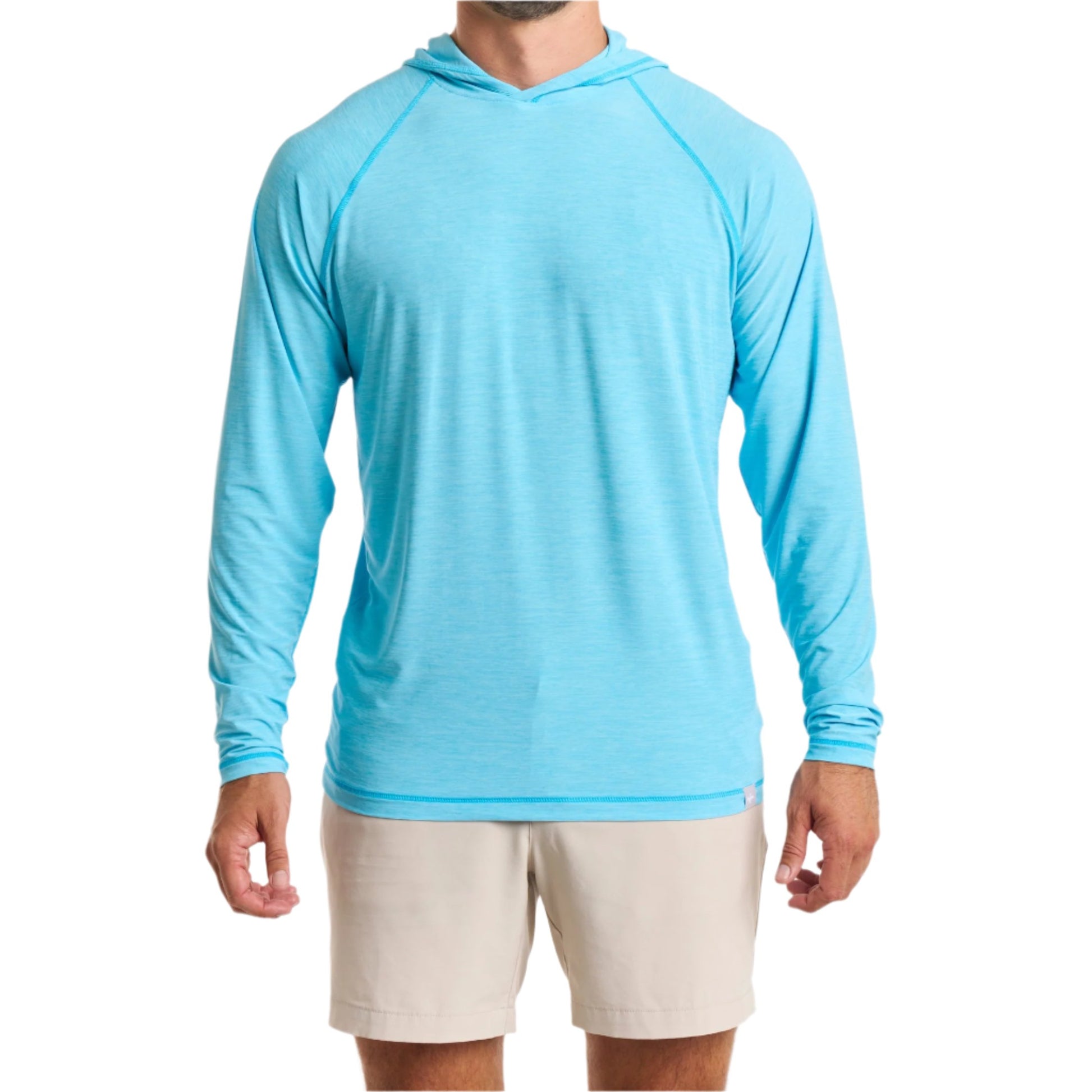 Close-up of a man wearing the Marsh Hoodie in sea island blue color with cream white color pants, cropped from chin to knees, against a solid white background.