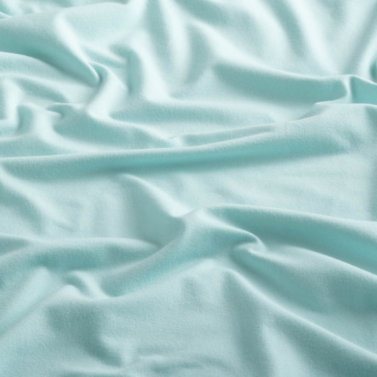 Close-up of the fabric of the Sport Hoodie in aqua color.