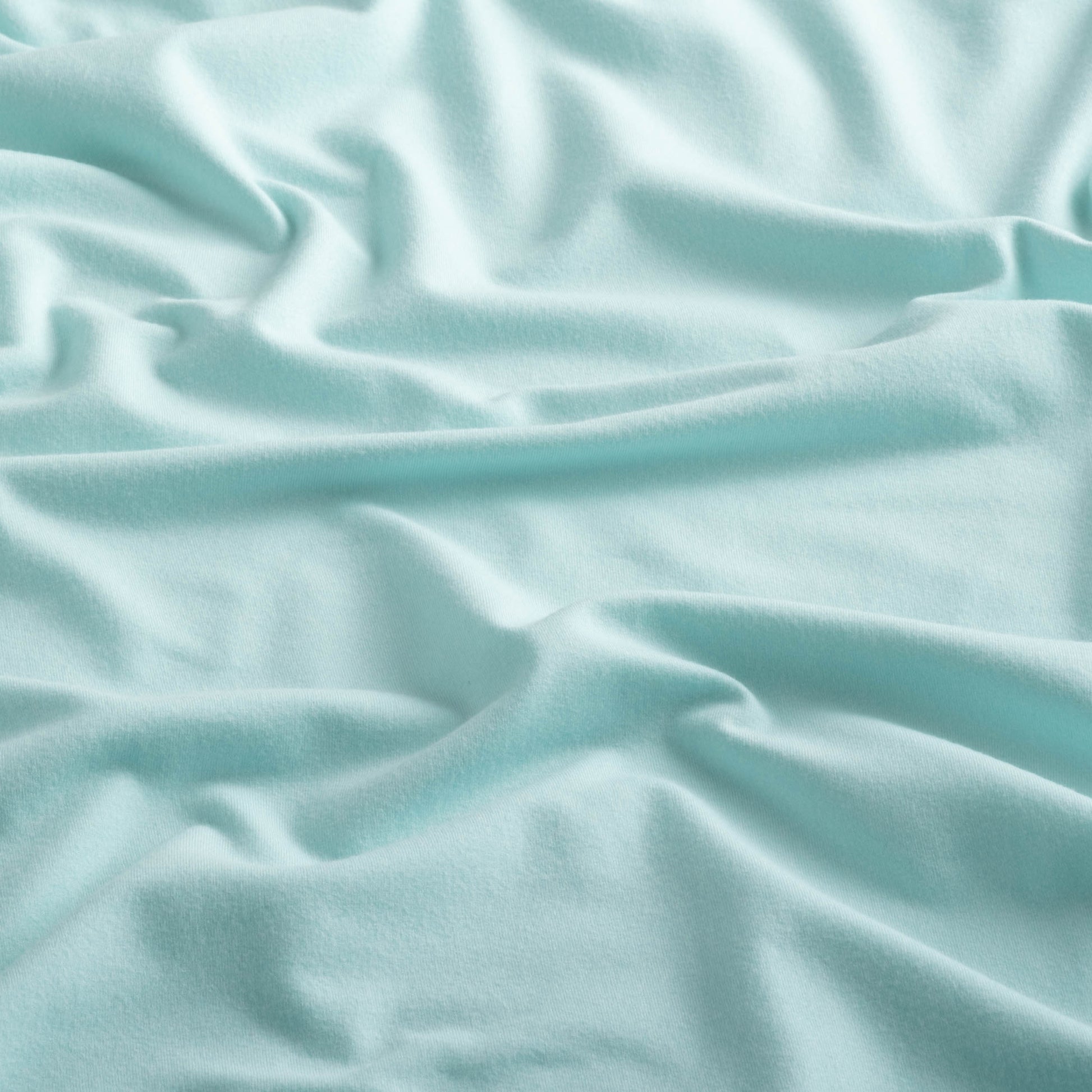Close-up of the fabric of the Sport Hoodie in aqua color.