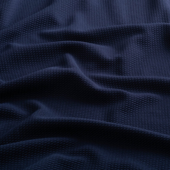 Close-up of the jacquard knit fabric of the Horizon Hoodie in Beaufain Blue.