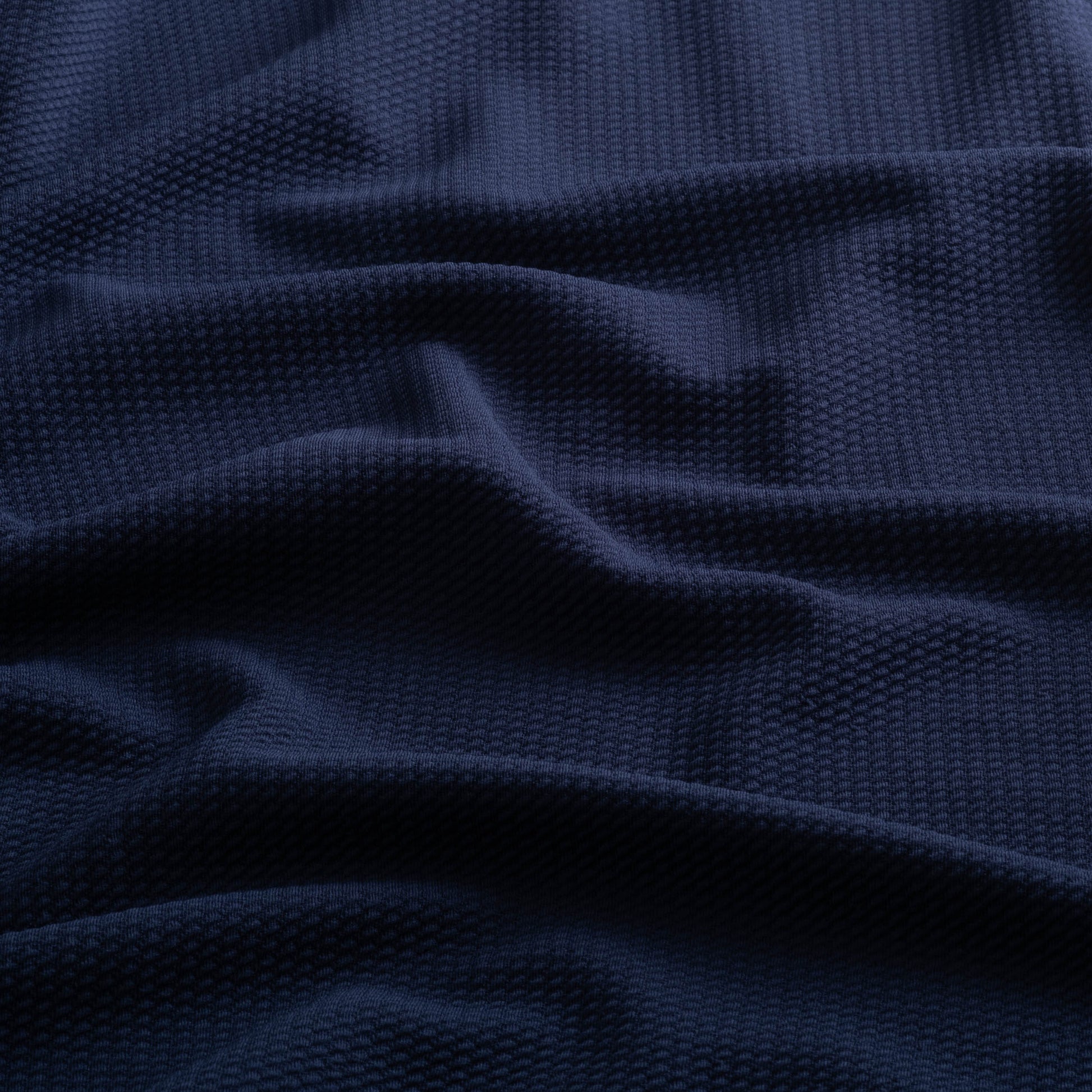 Close-up of the jacquard knit fabric of the Horizon Hoodie in Beaufain Blue.