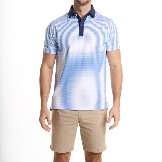 Close-up of a man wearing the Preston in sonic color with cream white color shorts, cropped from chin to knees, seen from front against a solid white background.