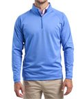 Close-up of a man wearing The Seabrook Performance 1/4 Zip in Marine Blue with white cream pants, cropped from chin to knees, against a solid white background.